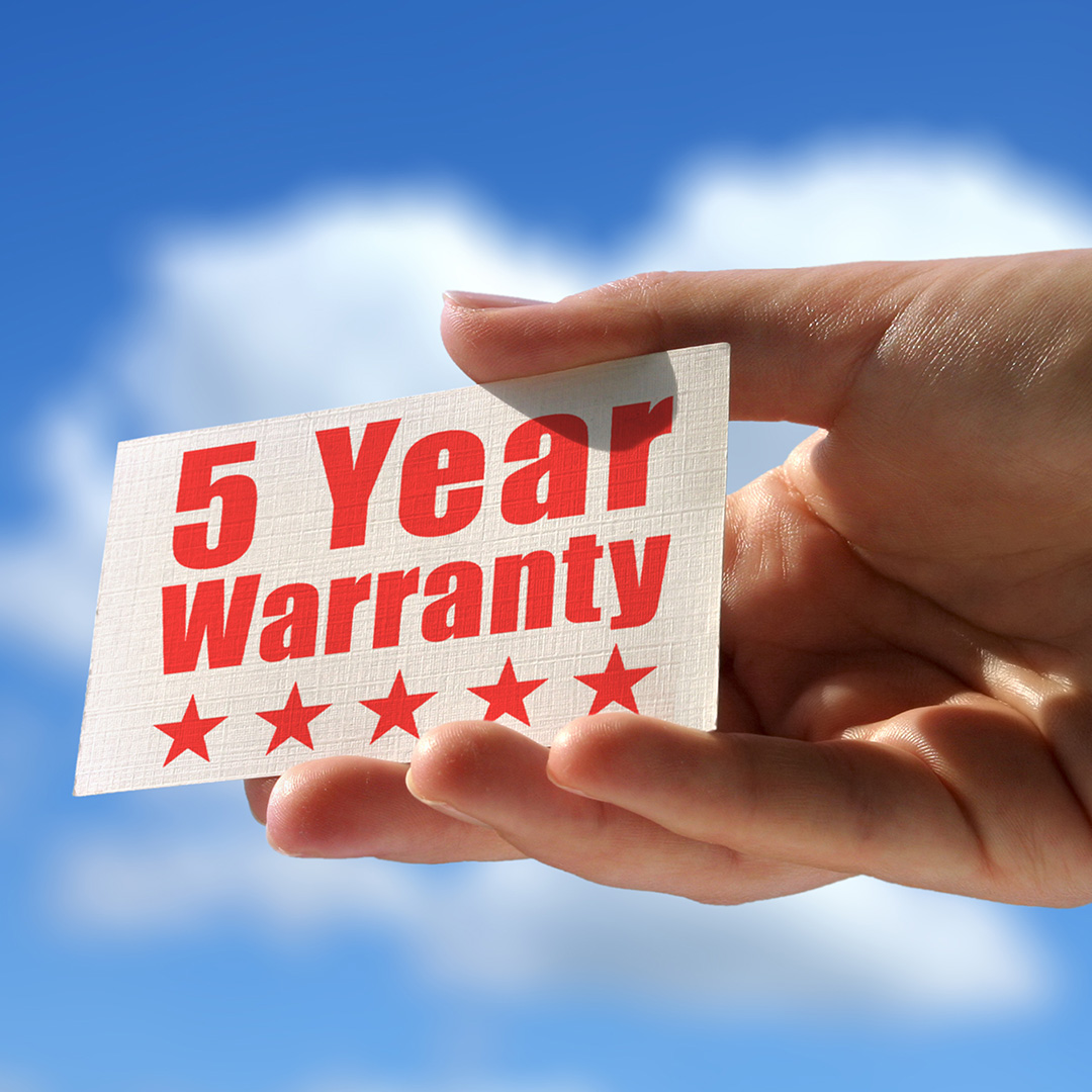 Person holding a white card with red letters that say five year warranty