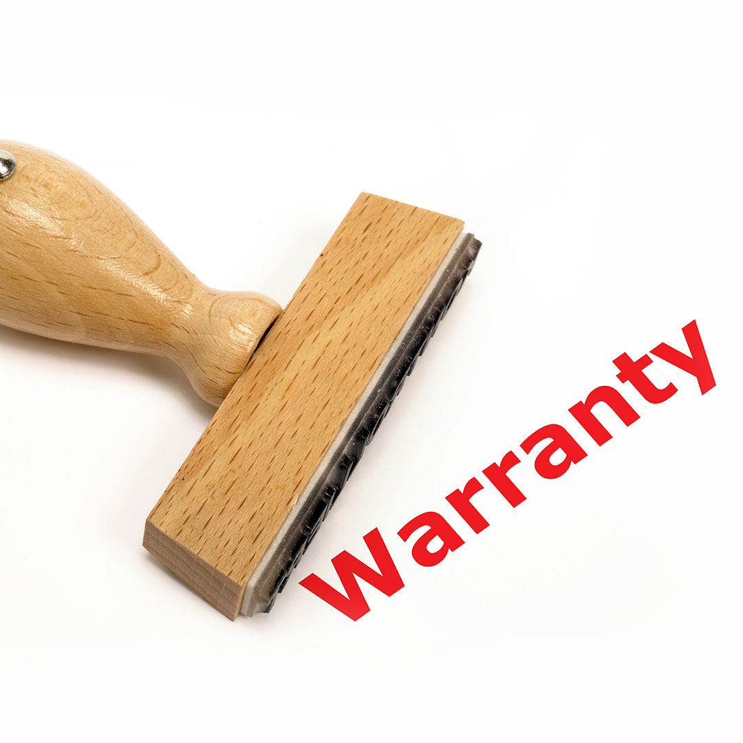 Wooden stamp that marked the word warranty in red ink